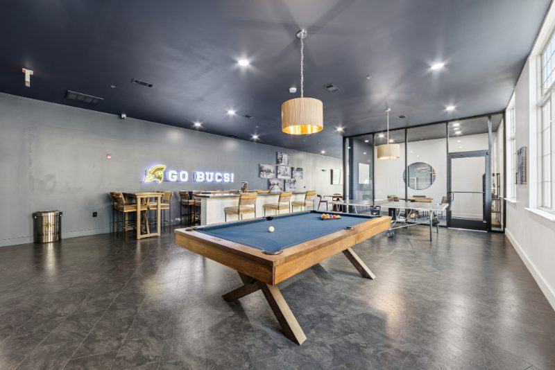 The game room with a pool table at The Harbor