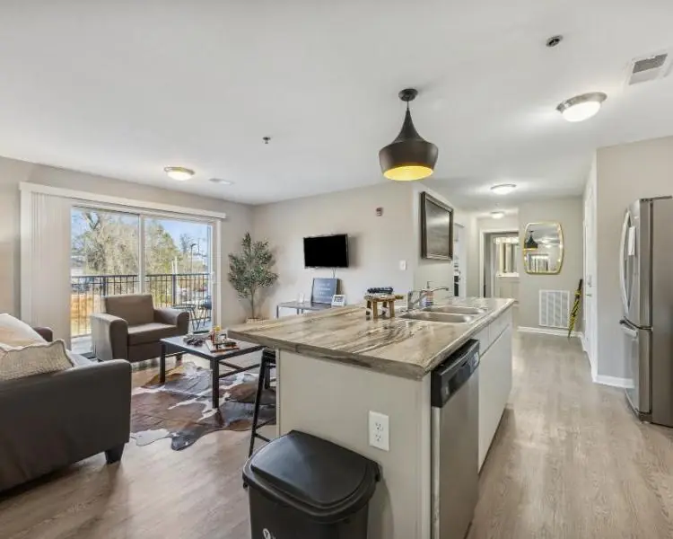 A furnished living room and kitchen at The Harbor