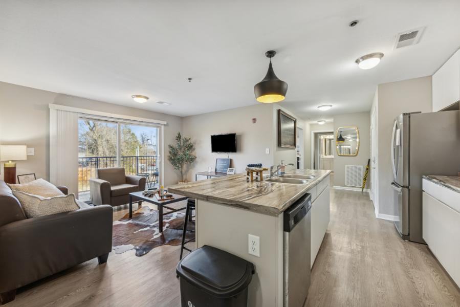 A furnished living room and kitchen at The Harbor